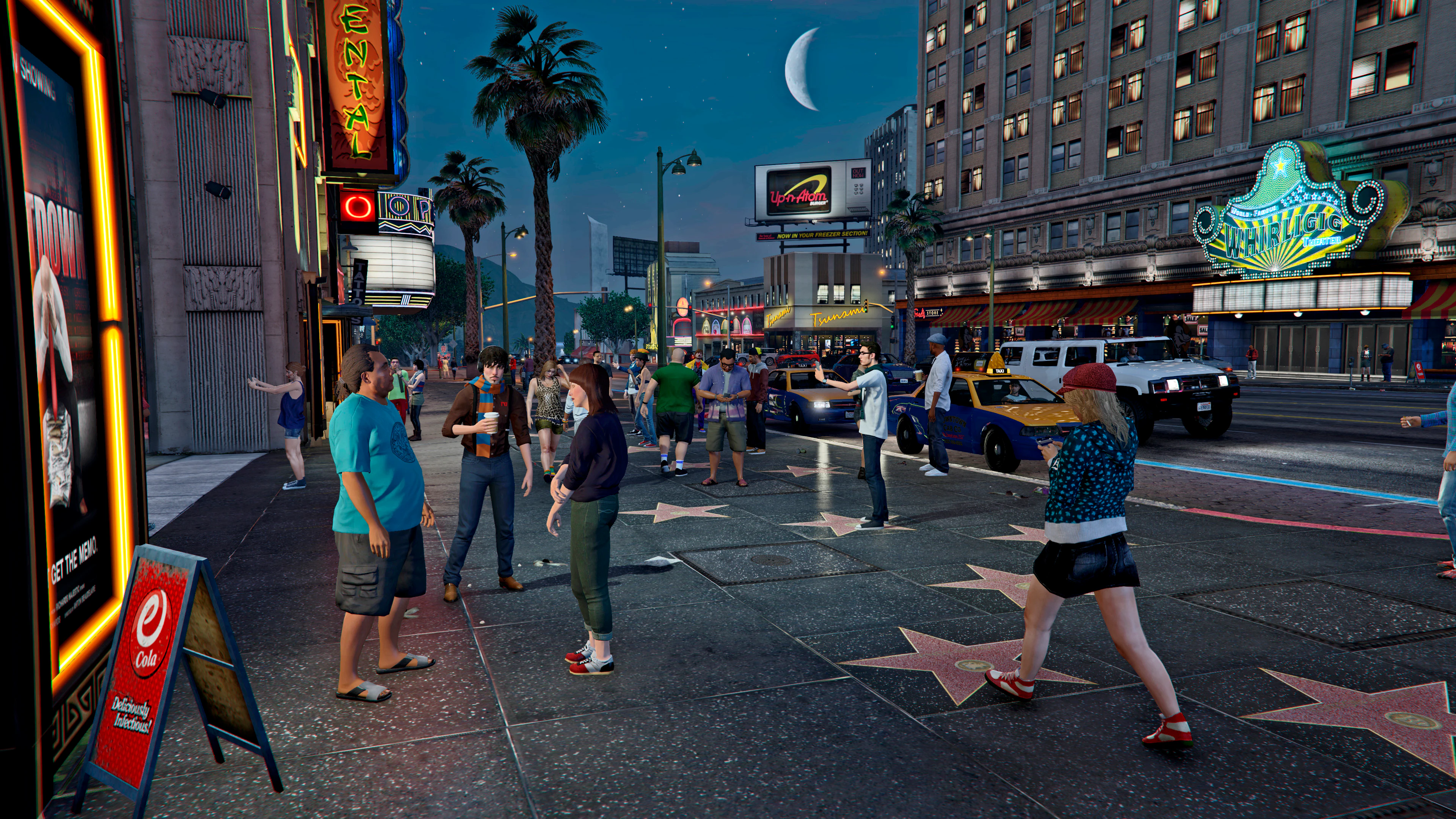 Theaters, marquees, stars, and crowds filling Vinewood after dark